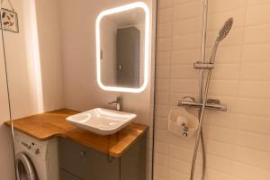 a bathroom with a sink and a shower at Face a la mer Cassis in Cassis +6 photos