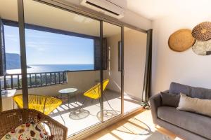 a living room with a view of the ocean at Face a la mer Cassis in Cassis