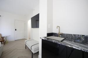 a kitchen with a counter top and a sink at The Lemon Branch Hotel in Miami Beach +56 photos