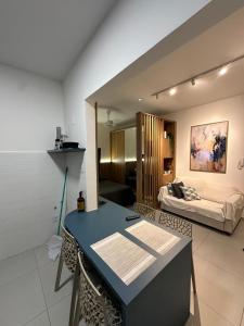 a living room with a table and a couch at House Brigadeiro in Juiz de Fora