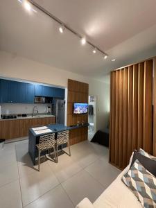 a kitchen with blue cabinets and a table in a room at House Brigadeiro in Juiz de Fora +29 photos