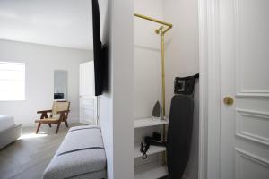 a white room with a bed and a door at The Lemon Branch Hotel in Miami Beach