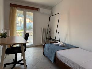 a bedroom with a bed and a desk and a table at Leka Village Our Hidden Gem in Léka
