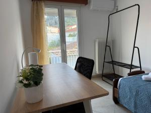 a dining room table with a potted plant on it at Leka Village Our Hidden Gem in Léka