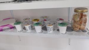 a shelf with cups and a jar on it at B&B VANNEFORA in San Nicola Arcella +61 photos