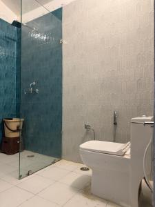 a bathroom with a toilet and a glass shower at Sukoon in Nainital +14 photos