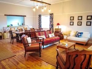 a living room with a couch and a table at Karoo Secret Secret House in Aberdeen