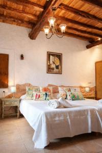 a bedroom with a large bed in a room at Can Pep Pardal in Sant Miquel de Balansat +28 photos