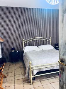 a bedroom with a bed and a striped wall at Da Adriana Guesthouse in Santa Teresa Gallura