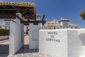 a hotel el cortino sign in front of a building at BLUESEA El Cortijo in Matalascañas