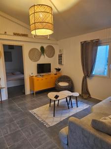 a living room with a couch and a table at Gîte Les Durands in Cahors