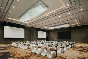 a conference room with tables and chairs and a screen at Amari Pattaya in Pattaya +215 photos