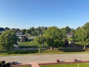 a view of a park with trees and a street at Upkammer im Park in Werdum