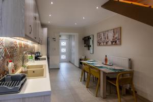 a kitchen and dining room with a table and chairs at Maleme Maisonette in Maleme