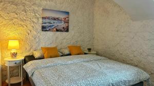 a bedroom with a bed and a painting on the wall at Nomads Village in Bled