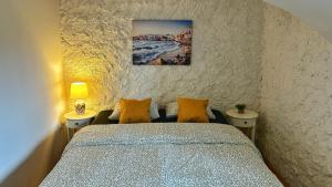 a bedroom with a bed and two tables and a painting on the wall at Nomads Village in Bled