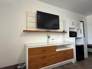 a tv sitting on top of a dresser in a room at Siesta Inn Sarasota - Indian Beach in Sarasota
