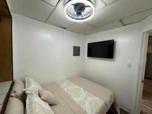 a bedroom with a bed and a flat screen tv at Anchorage Fireoved Experience in Anchorage