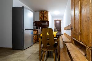 a kitchen with a table and a refrigerator at Agroturystyka Gościniec Ethoria in Łomnica