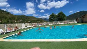 a group of people in a swimming pool at Chalet Chez Nous Castellane in Castellane