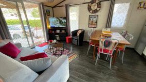 a living room with a table and a dining room at Chalet Chez Nous Castellane in Castellane