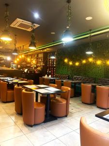 a restaurant with tables and chairs and a green wall at Universo Romantico in Lisbon