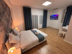 a bedroom with a bed with two teddy bears on it at Stadium Side Rooms in Craiova +13 photos
