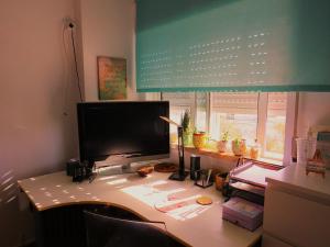 a desk with a computer monitor on top of it at Al-Madan in Almada