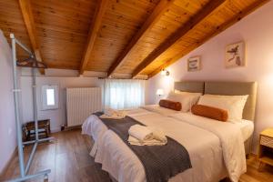 a large bed in a room with a wooden ceiling at Maleme Maisonette in Maleme