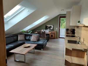 a living room with a couch and a table at Seehof Reuter Ferienhof in Metelen