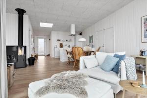 a living room with a white couch and a table at 20428-Samso-Radyrvej-10 in Langemark