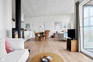 a living room with a couch and a table at 20428-Samso-Radyrvej-10 in Langemark