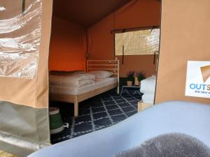 a small room with two beds in a tent at Safaritent 4 in Biddinghuizen +22 photos