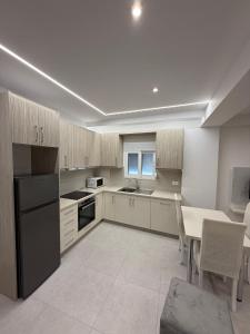 a large kitchen with a table and a dining room at Luxury Room's by Lika in Sarandë