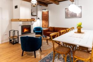 a living room with a table and chairs and a fireplace at Gabri Guesthouse Transylvania in Aita Seacă +55 photos