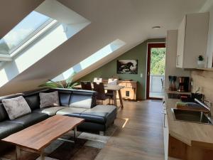 a living room with a couch and a table at Seehof Reuter Ferienhof in Metelen