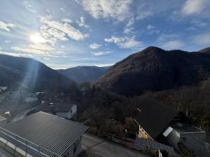 a view of a mountain with the sun shining on it at La Pergola in Auressio