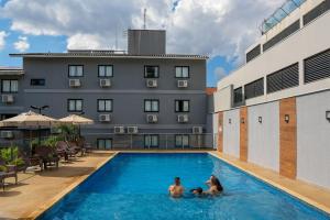 a group of people in the swimming pool of a hotel at Safa Hotel Foz in Foz do Iguaçu