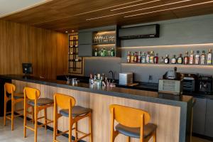 a bar with orange chairs at a restaurant at Safa Hotel Foz in Foz do Iguaçu