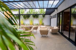 a patio with chairs and tables and plants at Safa Hotel Foz in Foz do Iguaçu