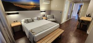 a bedroom with a large white bed and a table at Hotel Alvorada in Concordia +32 photos