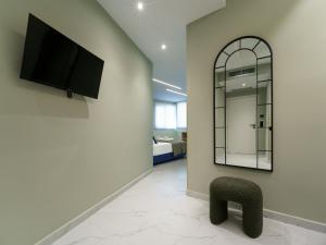 a living room with a chair and a mirror at Ernest Suites Psiri in Athens