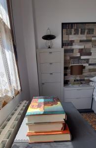 a stack of books sitting on a table in a bedroom at Apartamento Mar in Bádames