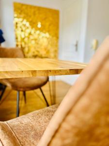 a wooden table and chairs in a room at Suite Dreams Bremen in Bremen +11 photos