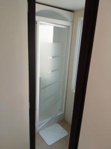 a reflection of a white closet in a mirror at Le mobil home bleu ! Camping Naturiste in Montalivet-les-Bains