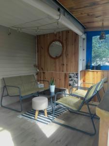 a room with two chairs and a table and a couch at Le mobil home bleu ! Camping Naturiste in Montalivet-les-Bains
