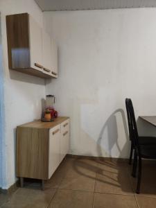 a kitchen with a wooden cabinet and a table at Raízes do Sertão - Vale do Catimbau in Buíque +9 photos