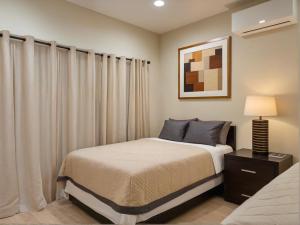 a bedroom with a bed and a lamp and curtains at Stylish 2, 3 and 5 Bedroom Entire Homes Near Art Deco and LA Hotspots in Los Angeles +101 photos