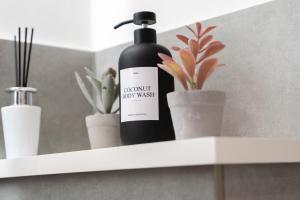 a bottle ofconscious boy wash sitting on a shelf at Jasmin Place in Luton