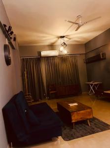 a living room with a couch and a table at Skyline Serenity by Vantage View in Nalmatha